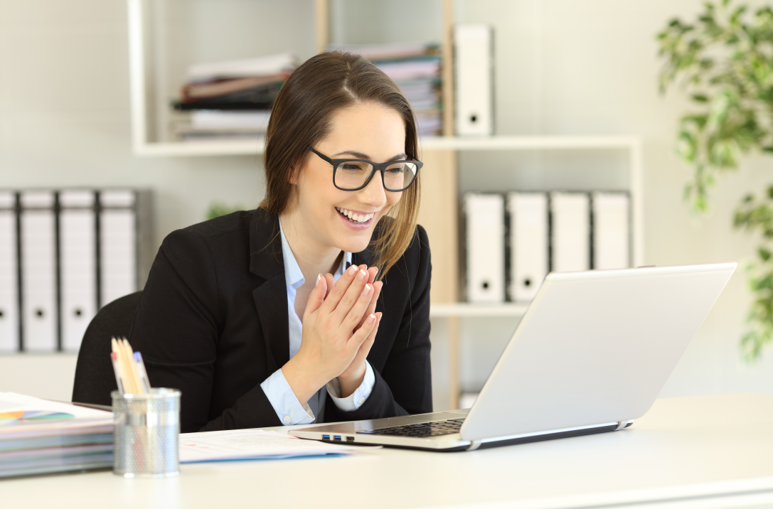 photo of woman happy in front of computer.